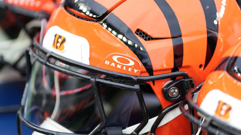 An Oakley brand shield is seen attached to a Cincinnati Bengals helmet on the bench before an...
