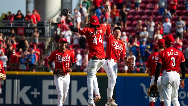 Cincinnati Reds shortstop Elly De La Cruz (44) and outfielder TJ Friedl (29) high-five after...